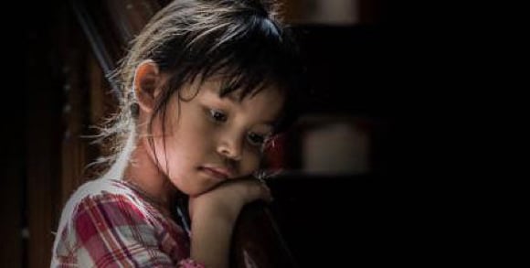 Iosis Foster Care Iosis Foster Care - Small girl with head in her hands