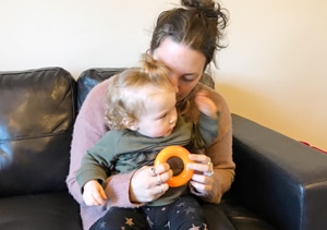 Iosis: Our Stories - Danielle playing with her baby daughter