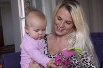 Letechia holding her baby daughter